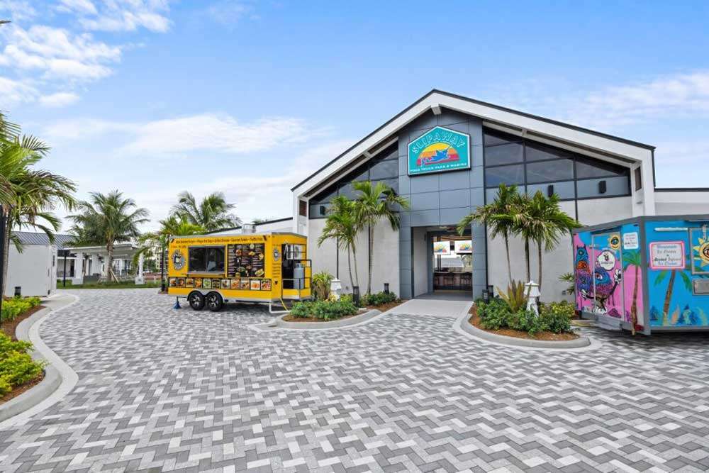 Food truck outside a modern restaurant building.