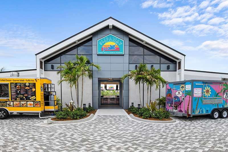 Food truck park entrance with colorful trucks
