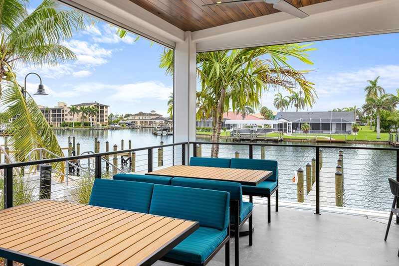 Outdoor seating area overlooking a tranquil waterway.