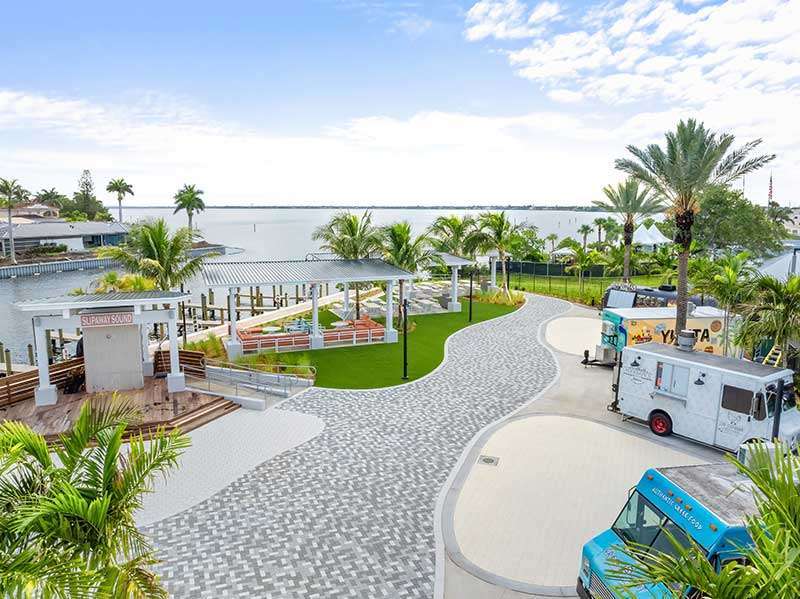 Waterfront area with trees and food trucks