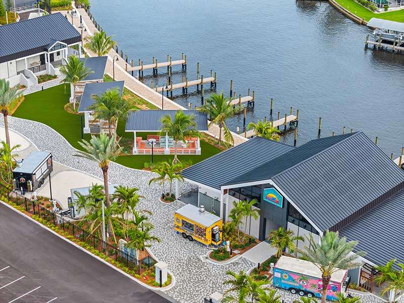 Aerial view of waterfront venue with food trucks.
